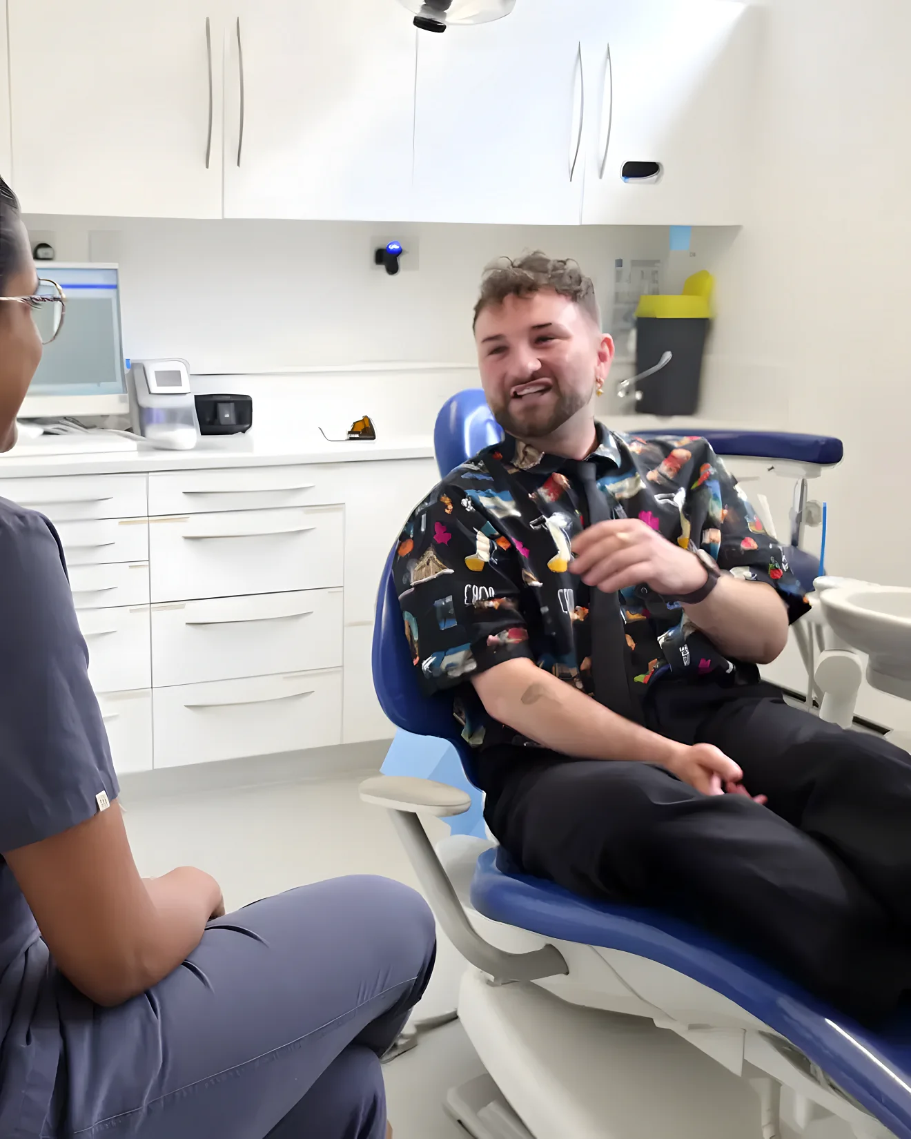 A patient smiling after Invisalign treatment at Blue Light Dental