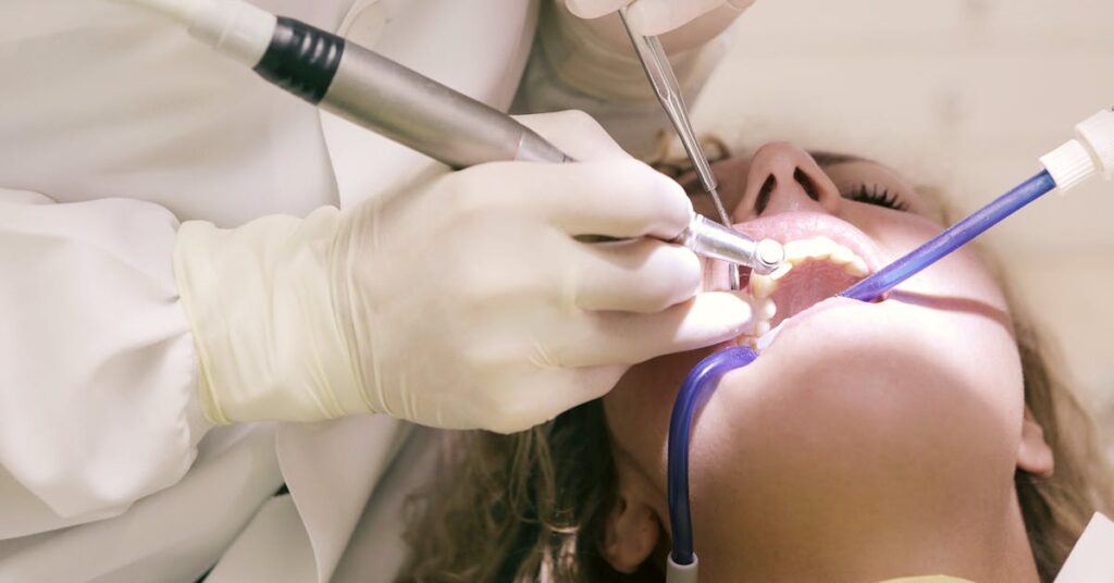 Dentist working on a patient's teeth — comparing dental crowns and bridges