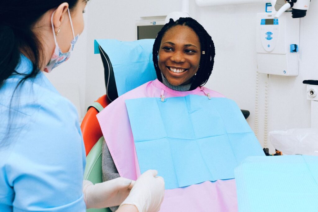 Patient smiling with a hygienist at the start of a dental hygiene appointment in a modern dental practice