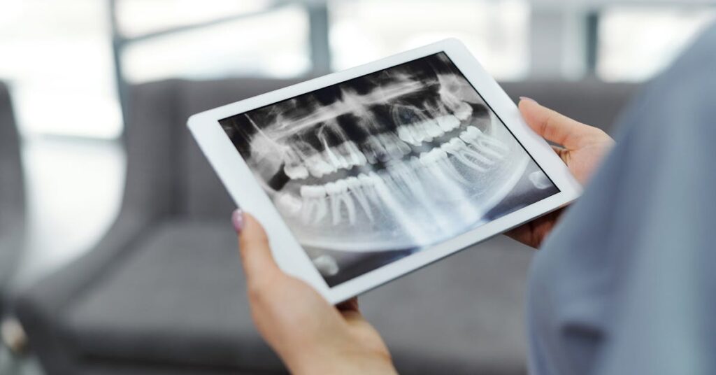 Dental X-ray on a tablet — planning dental implants before winter