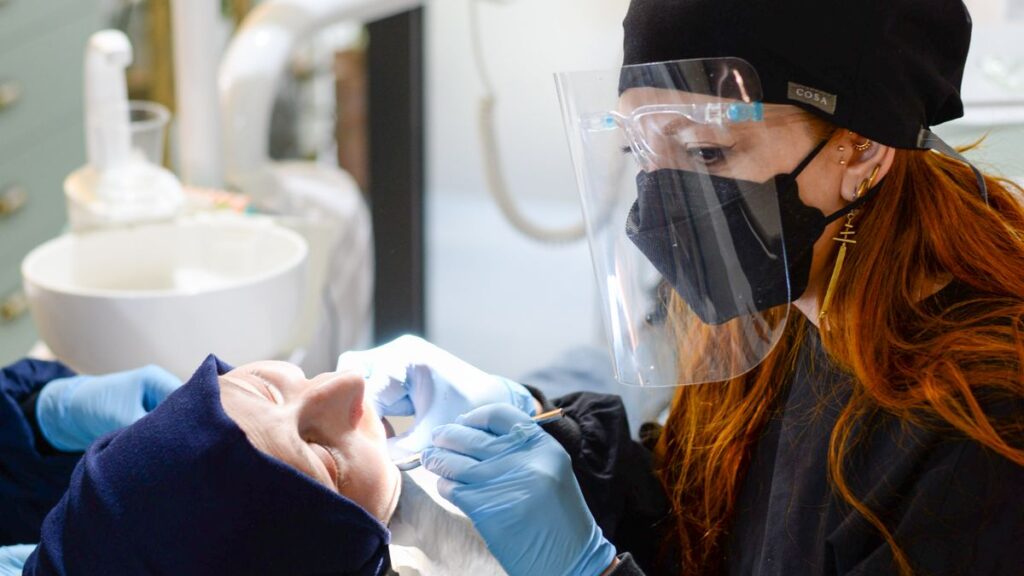Dentist treating a patient in the chair at an emergency dentist in North London