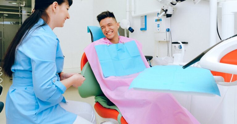 Patient in a dental chair smiling — healthy smile habits between dental visits