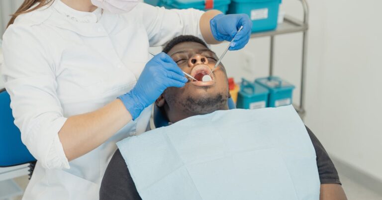 Dentist working with a patient — choosing a qualified clinician matters when comparing cheap dental implants