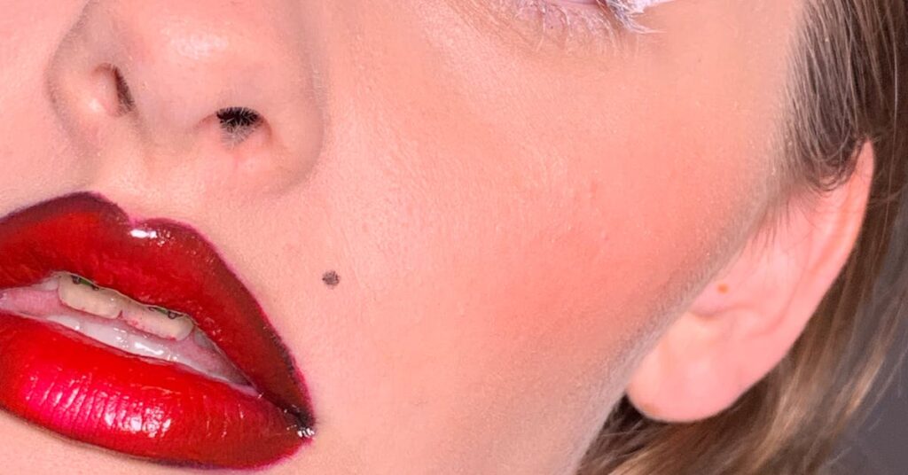 Woman with red lipstick and clear skin — benefits of anti-wrinkle treatments