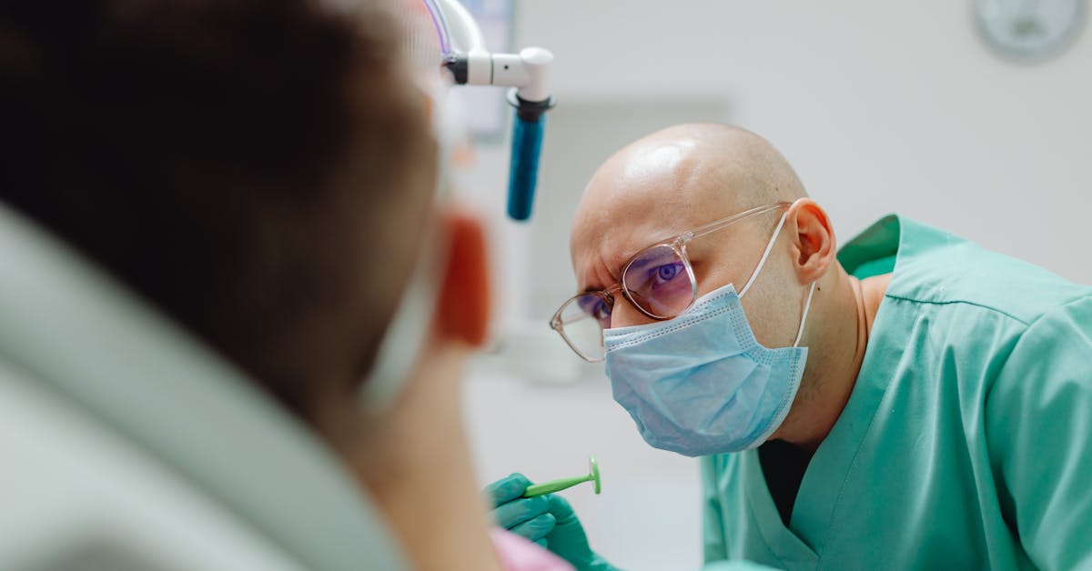 Dentist examining a patient — assessing a dental abscess in clinic