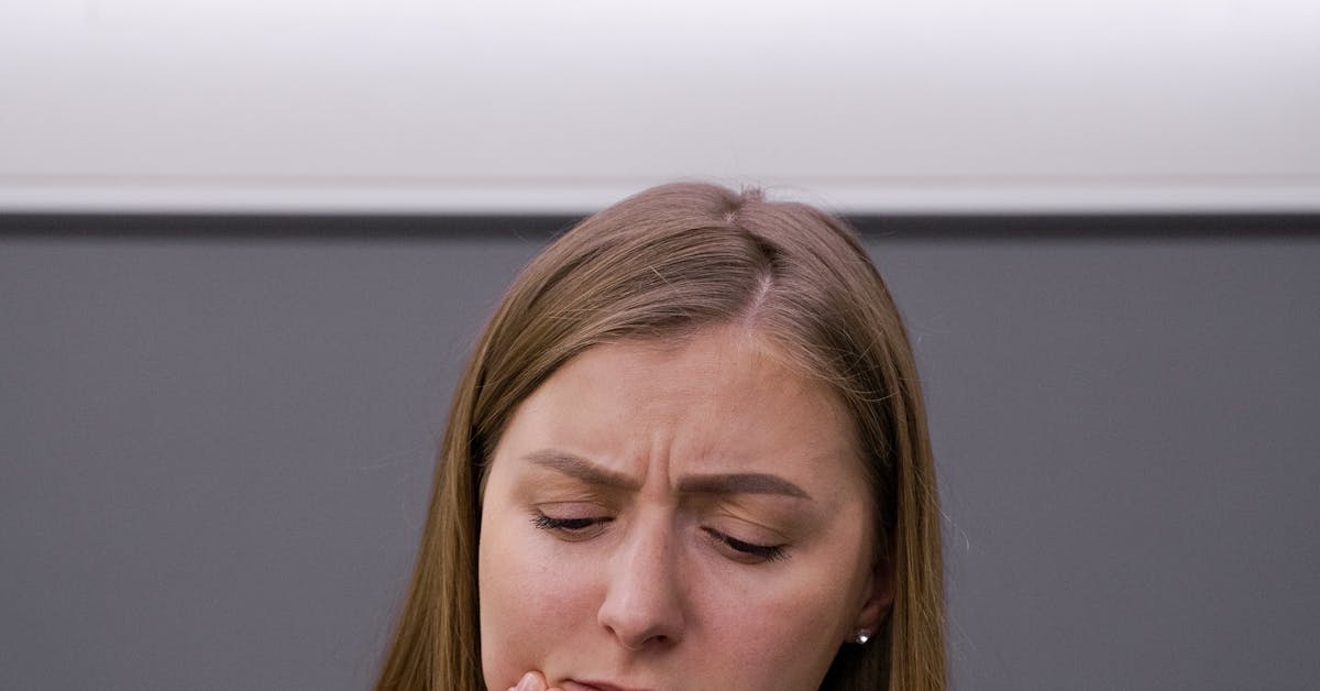 Woman holding her cheek in pain — dealing with wisdom teeth pain